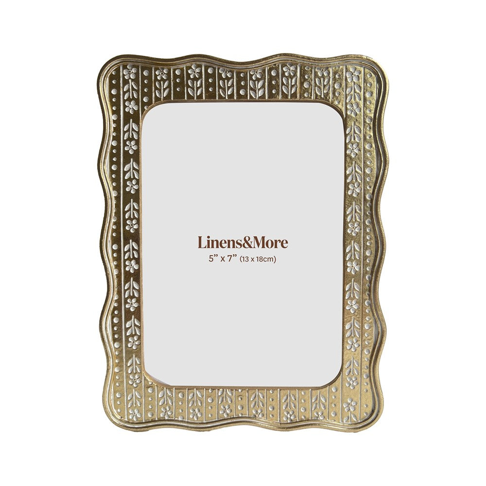 Decorative gold photo with white floral pattern inlay frame with 'Linens & More' branding on a white background