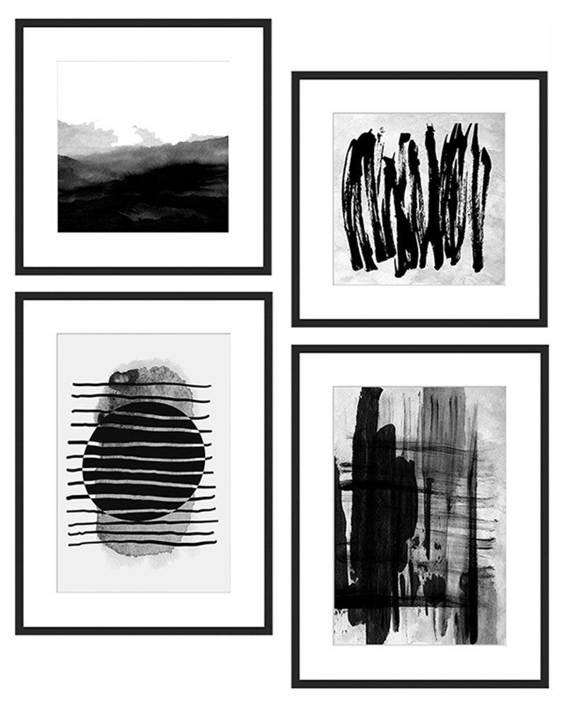 Set of four black and white abstract art prints in frames.