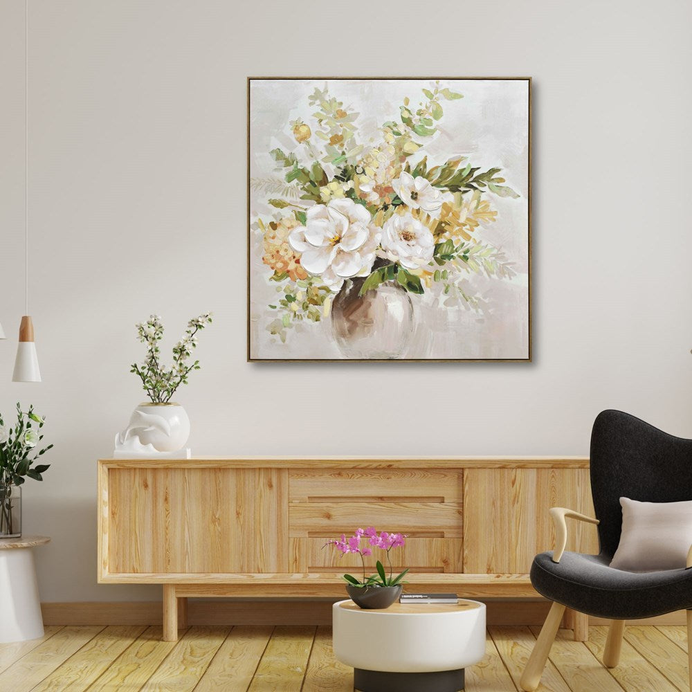 Living room with floral artwork on the wall, wooden cabinet, and black armchair.