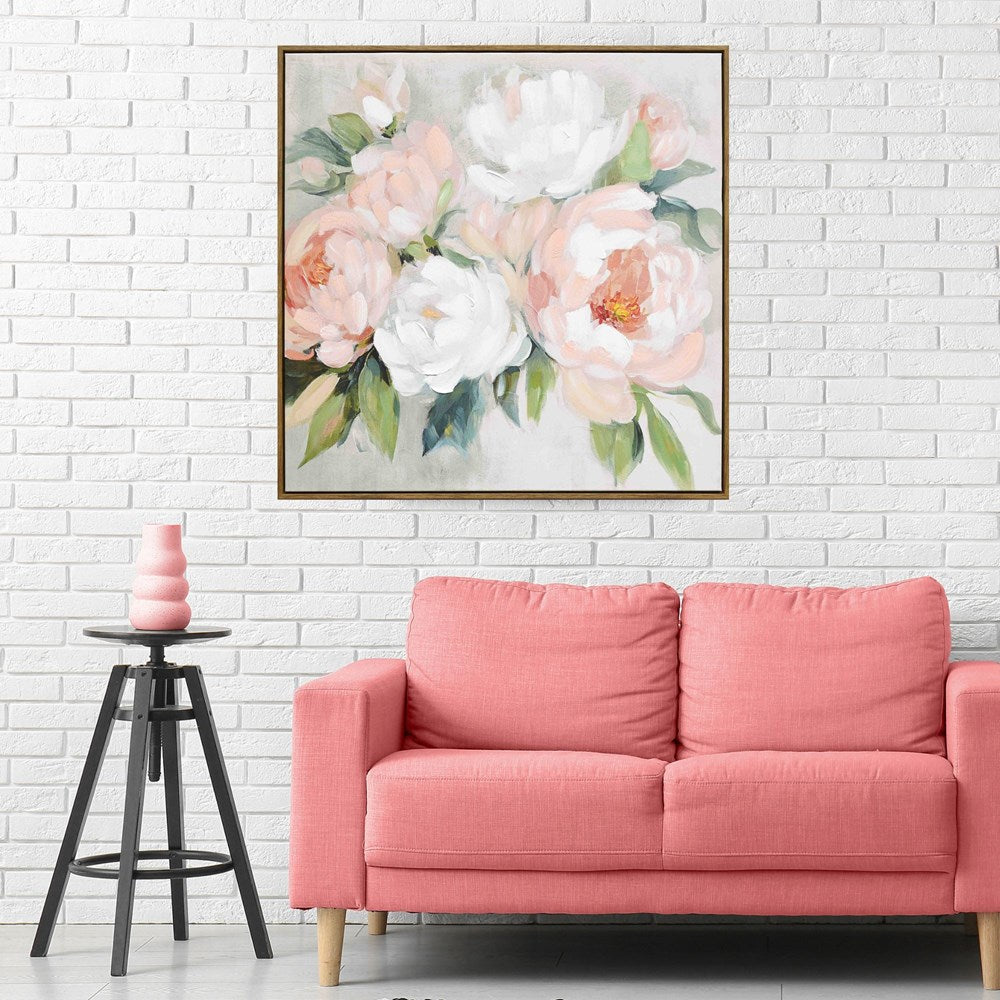 Floral painting above a pink sofa in a room with white brick walls.