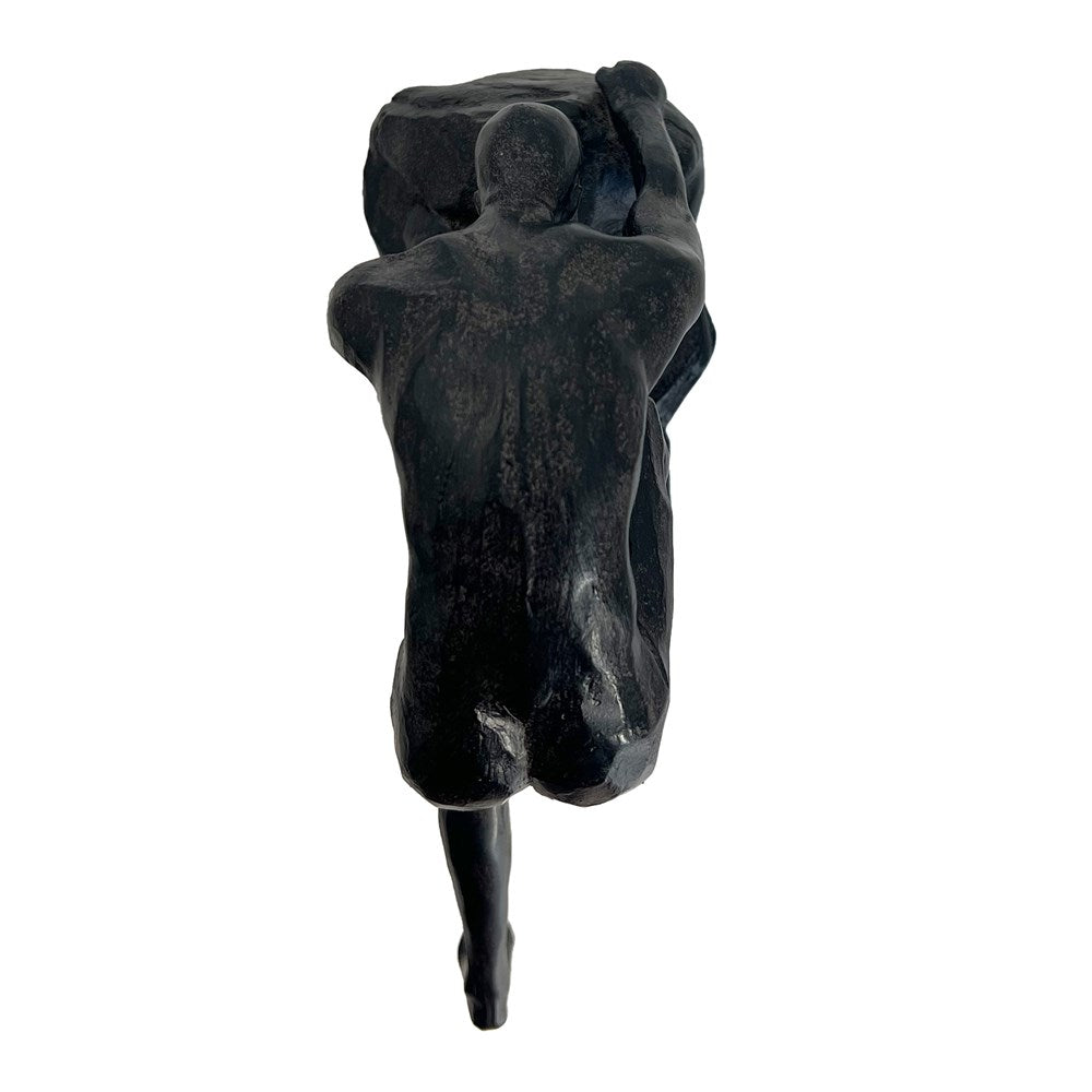 Aged sculpture of a man climbing on a white background