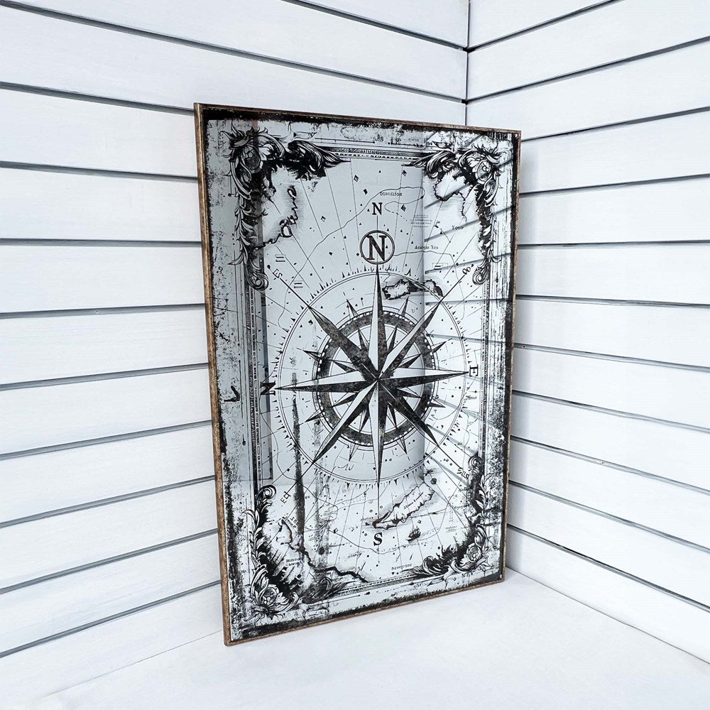 Decorative wall art with a compass design on a white wooden panel background