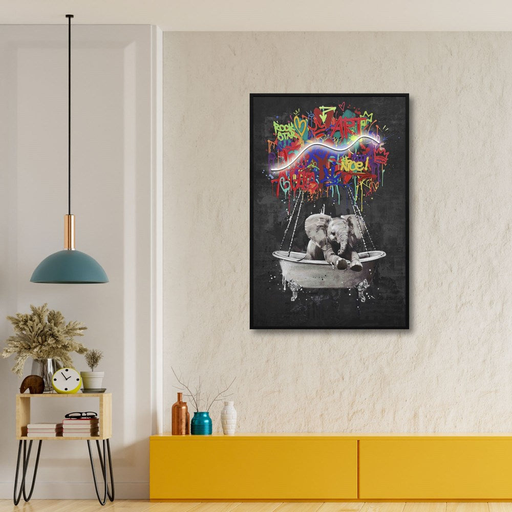 Framed artwork with colourful text and a led light on a wall in a room with a yellow cabinet and decorative items.