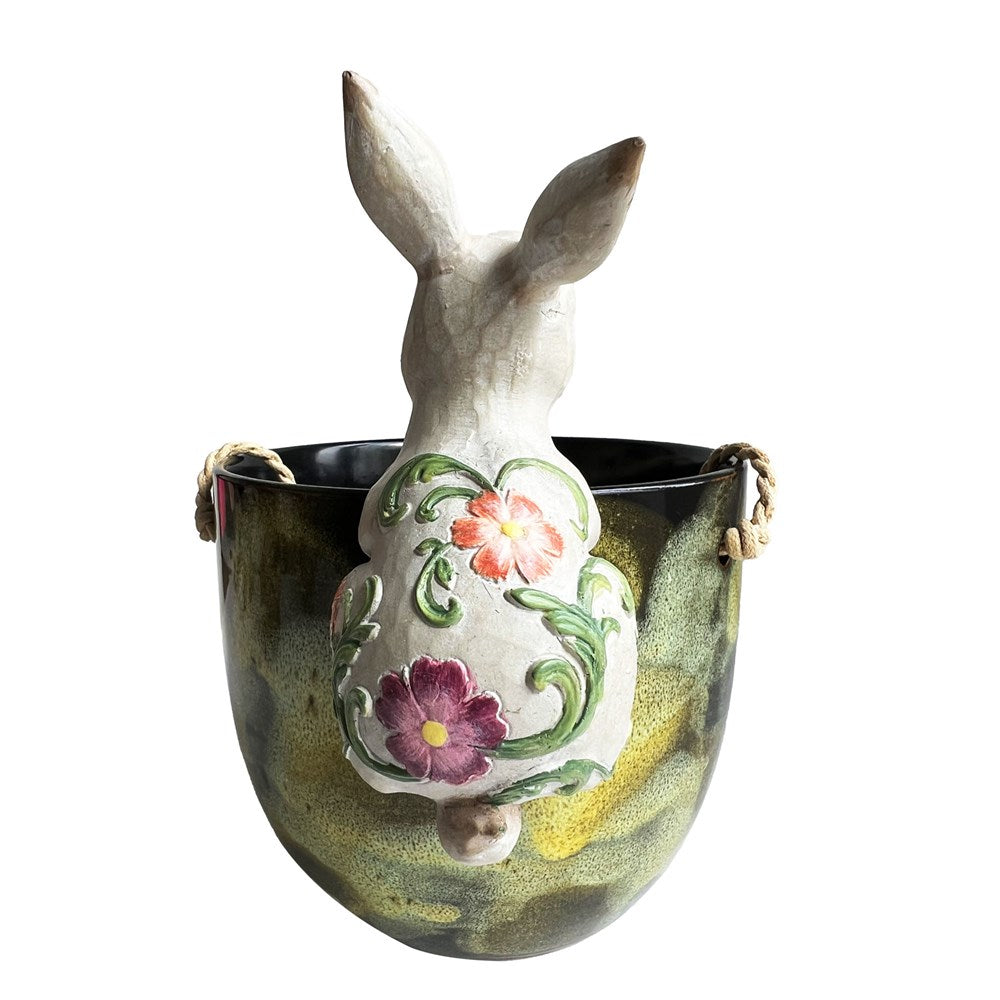 Decorative rabbit with floral design hanging on a planter pot back profile