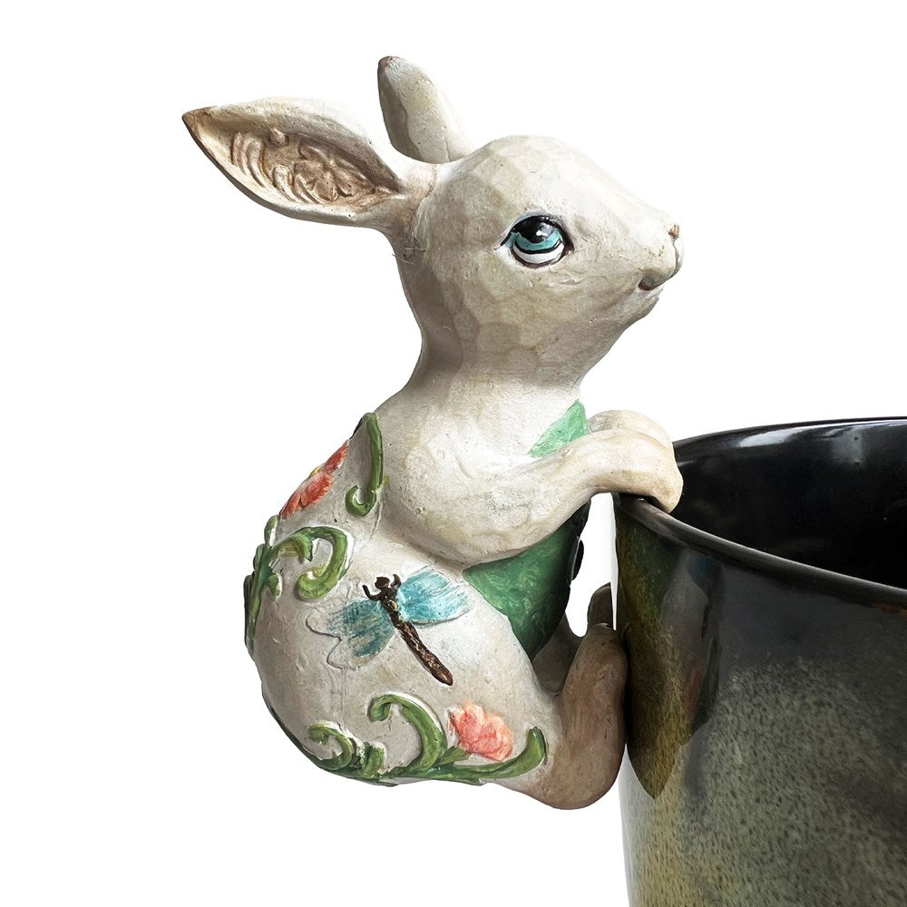 Decorative rabbit with floral designs hanging on planter pot