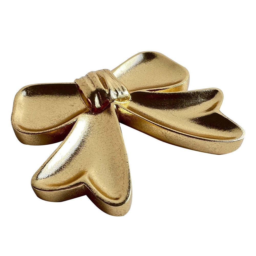 Gold bow shaped dish on a white background