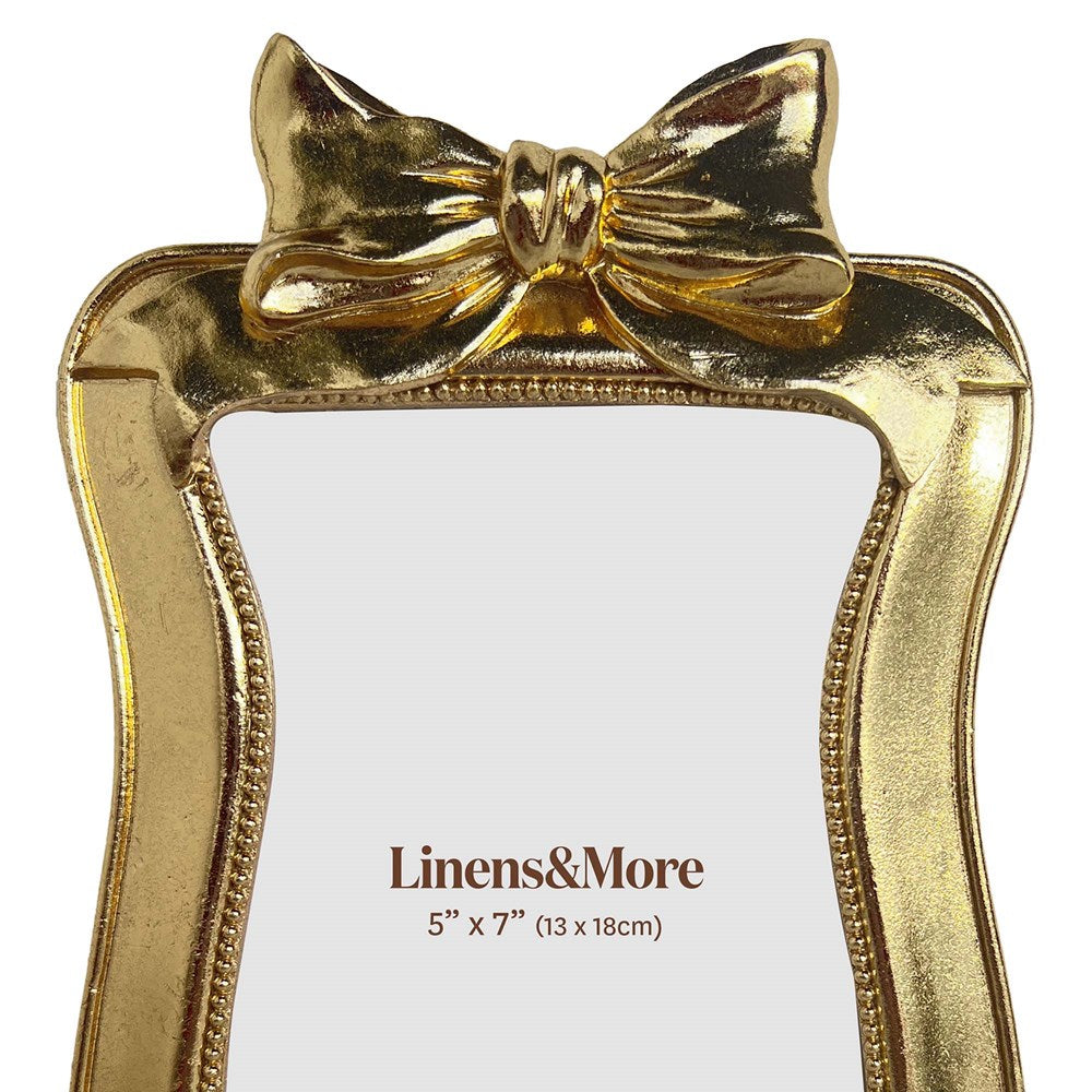 close up of gold photo frame on white background