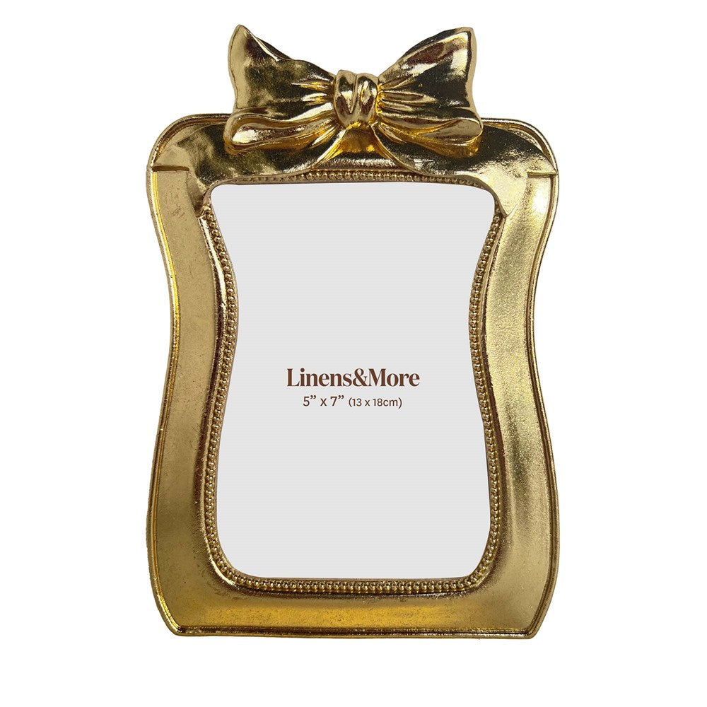 Gold picture frame with a bow on a white background.