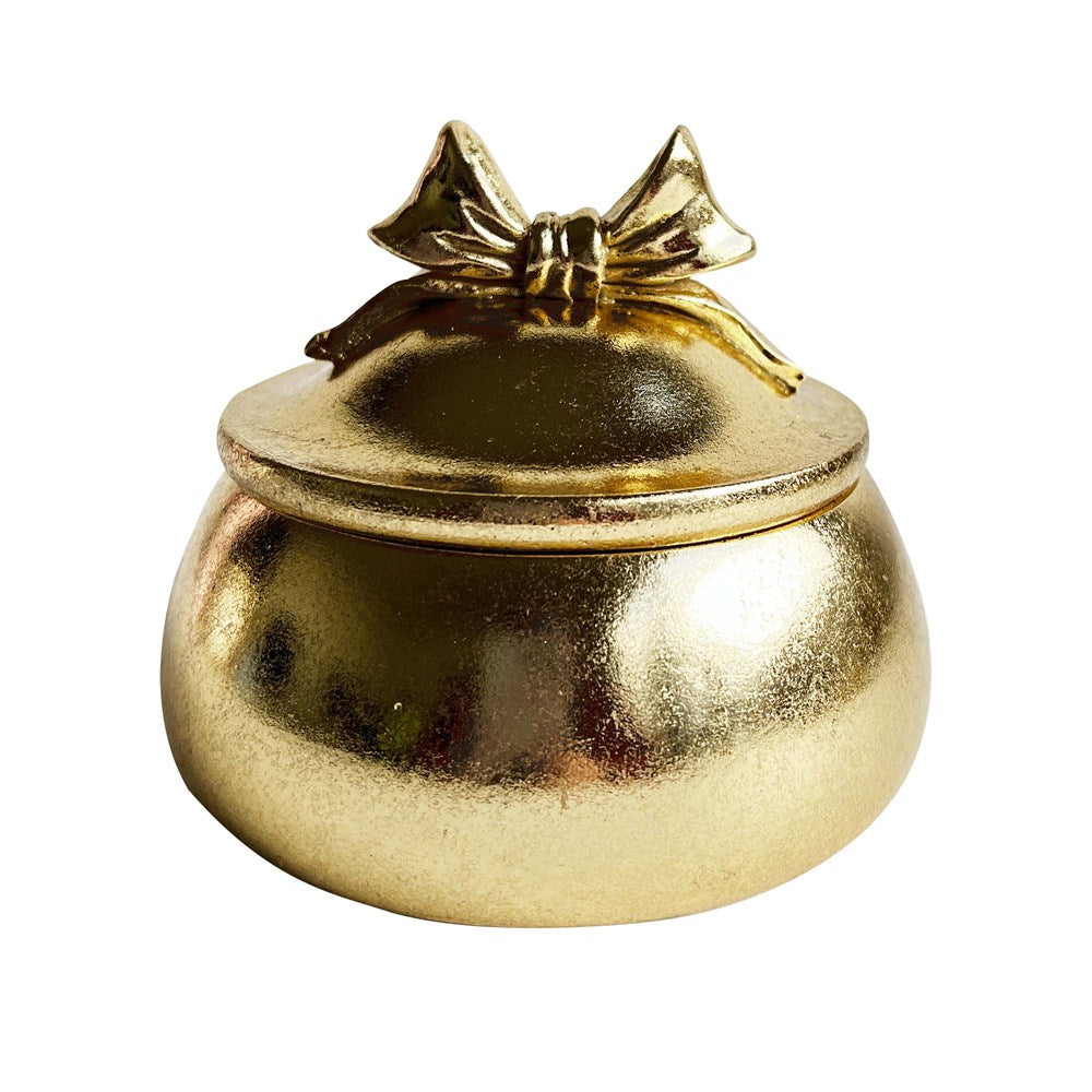 Gold decorative trinket box with a bow on a white background