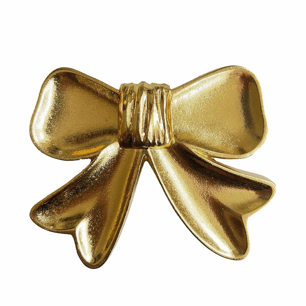 Gold bow-shaped dish on a white background