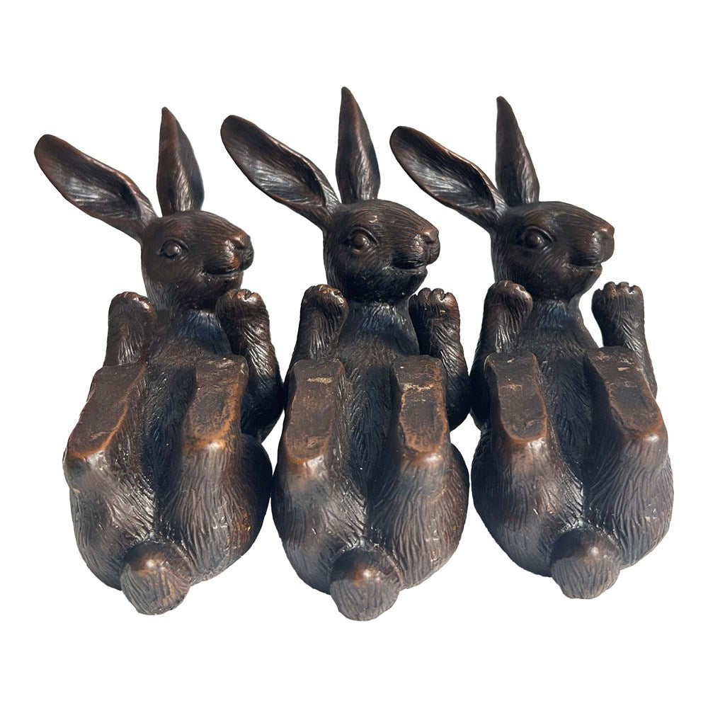Three aged hare pot holders on a white background