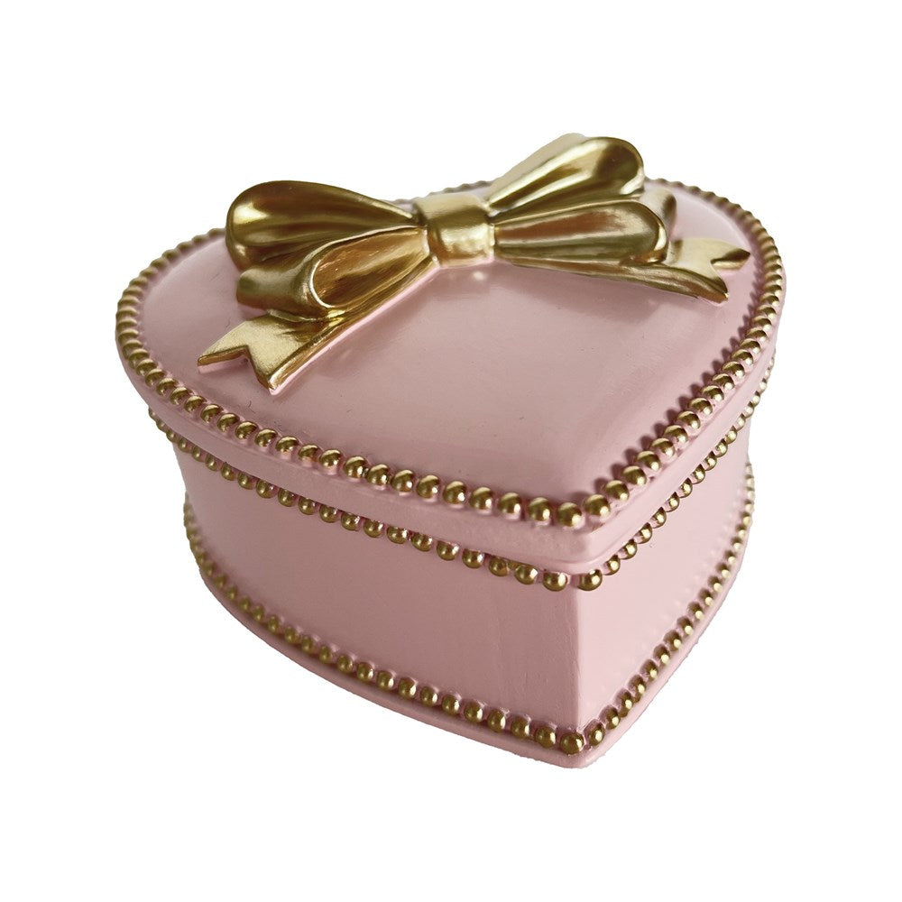 Pink heart-shaped box with a gold bow on a white background