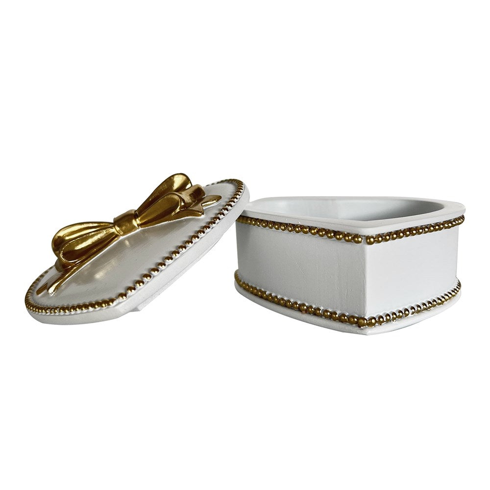 White jewelry box with lid ajar gold accents on a white background