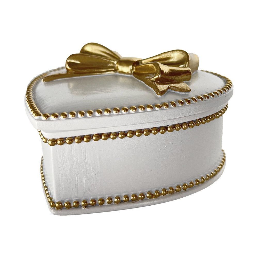 White jewelry box with gold accents and a bow on a white background