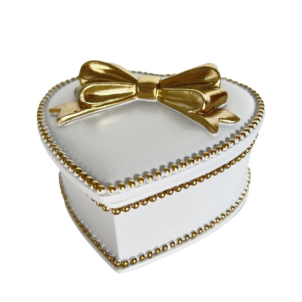 Heart-shaped white box with gold trim and a bow on a white background