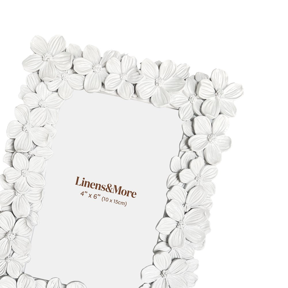 Floral white picture frame with 'Linens & More' branding on a white background