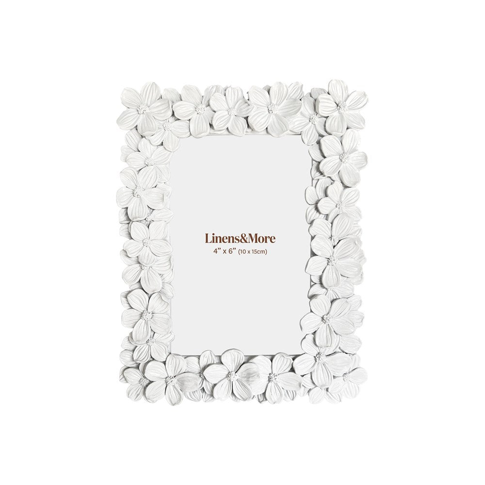 White floral picture frame with 'Linens & More' branding on a white background