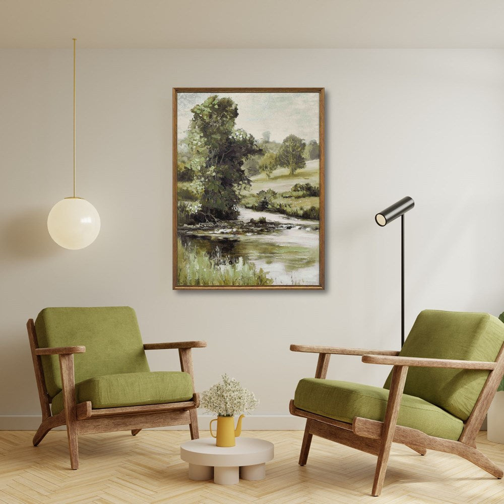 Two green armchairs in a living room with a landscape painting on the wall.