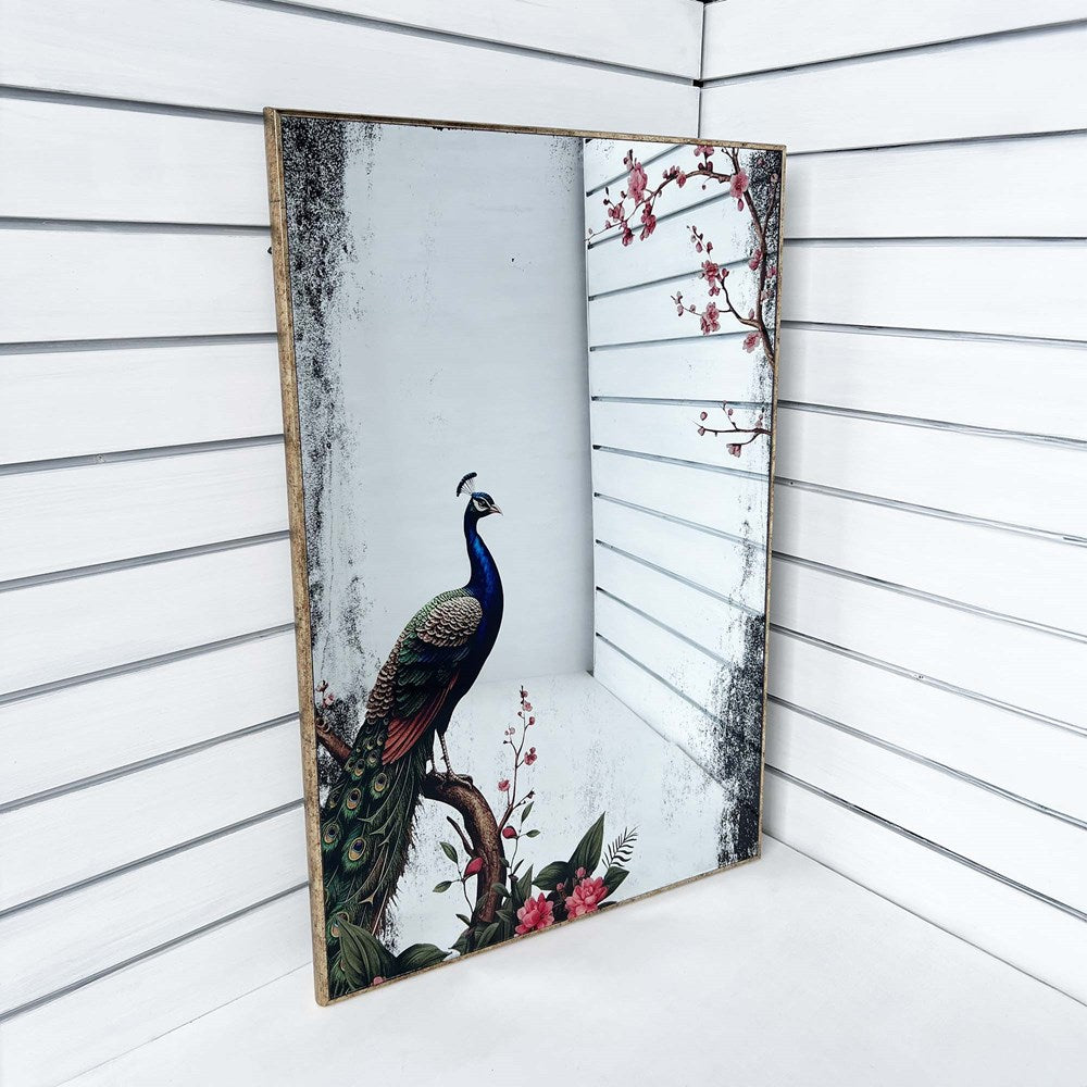 Decorative mirror with a peacock design on a white wooden background