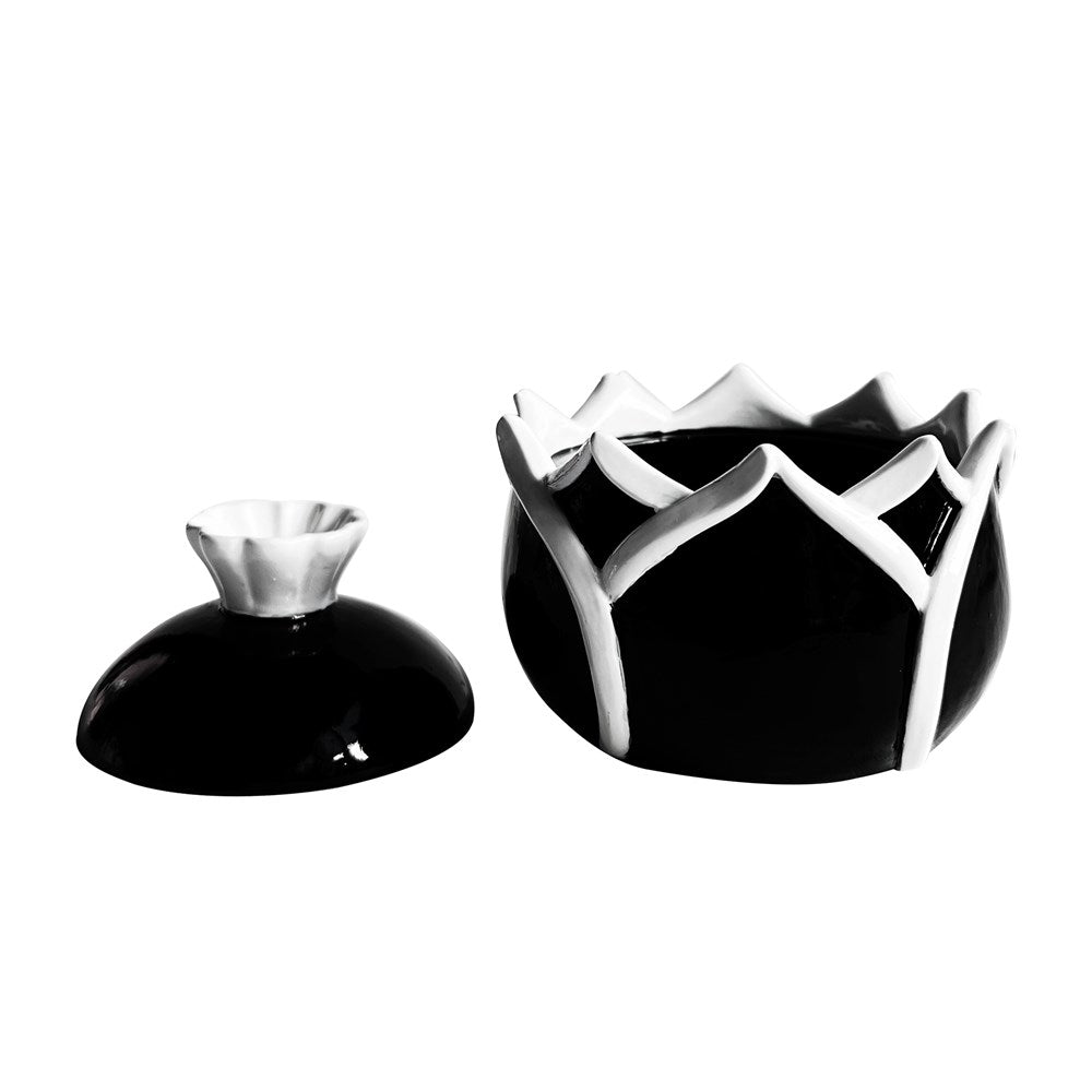 Black and white petal shaped box with lid ajar on a white background