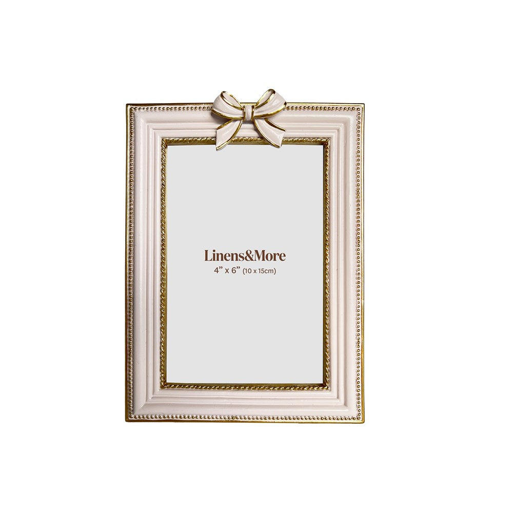 Decorative picture frame with a bow on a white background, featuring the brand 'Linens&More'.
