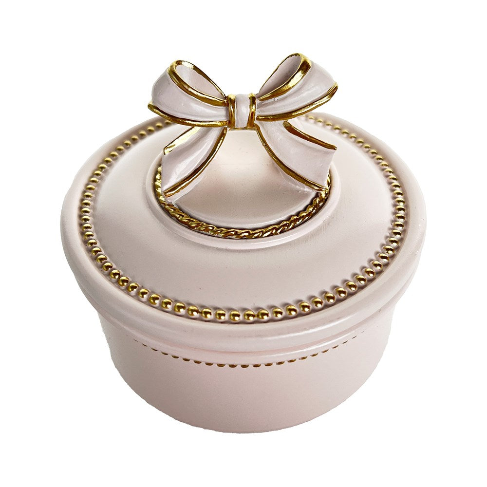 Close up of pink and gold trinket box on a white backgroud