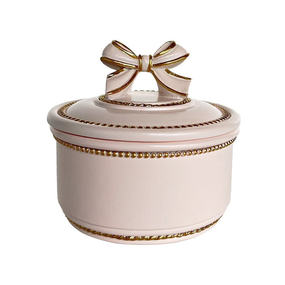 Decorative pink trinket box with a gold bow on a white background