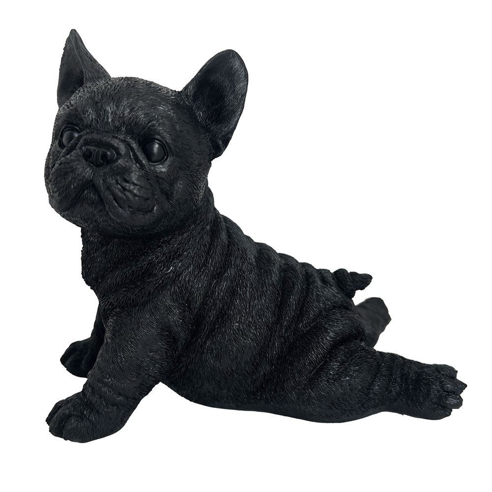 Black figurine of a lying dog on a white background