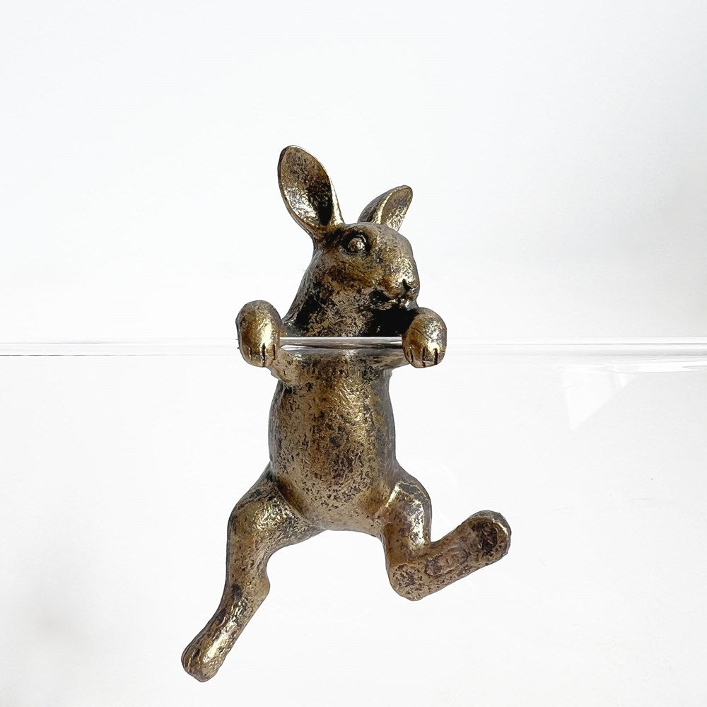 Gold rabbit-shaped ornament on a white background