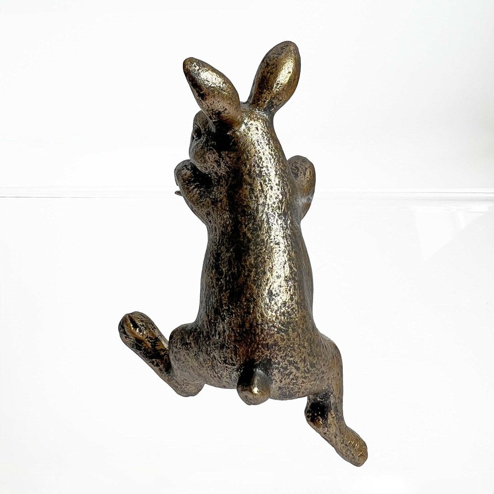Gold rabbit figurine on a white background