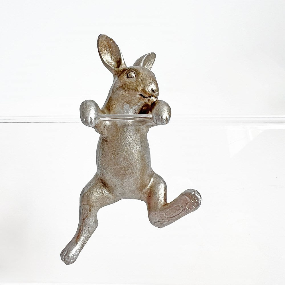 Metallic rabbit-shaped bottle opener on a white background