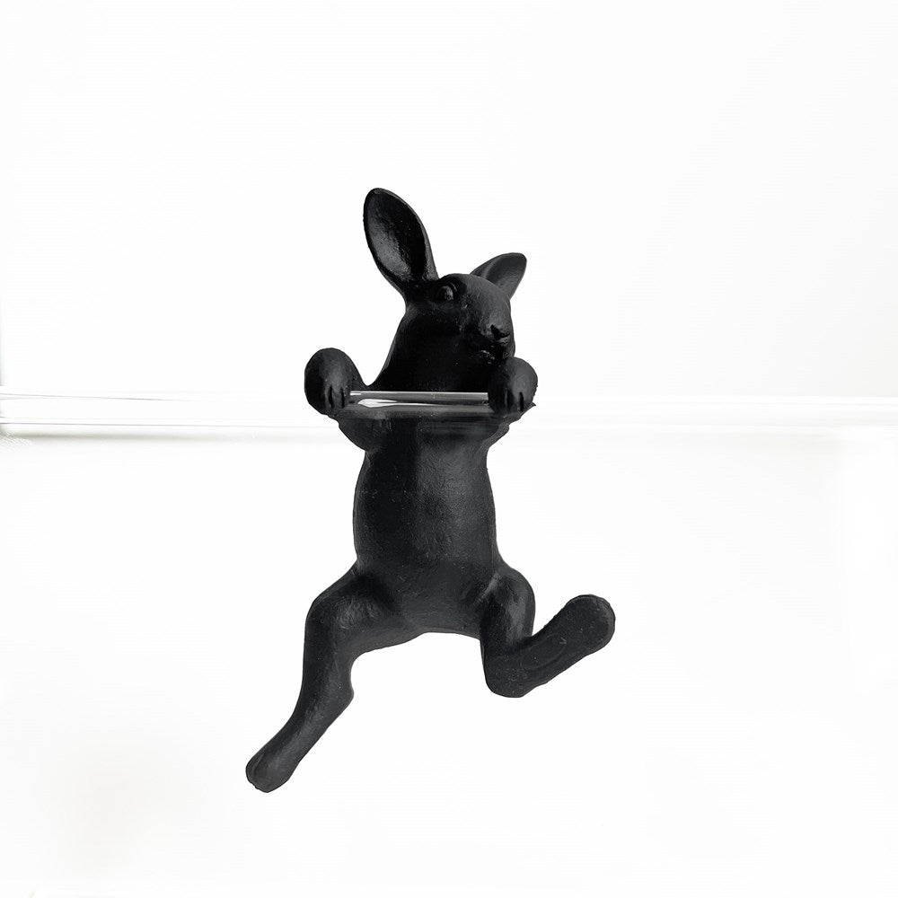 Black rabbit-shaped candle holder on a white background