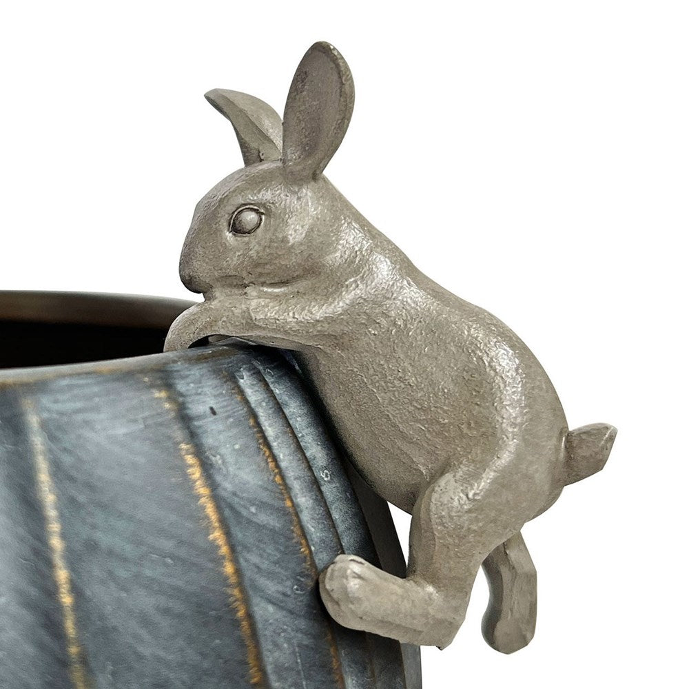 Decorative metal rabbit on a pot with a white background