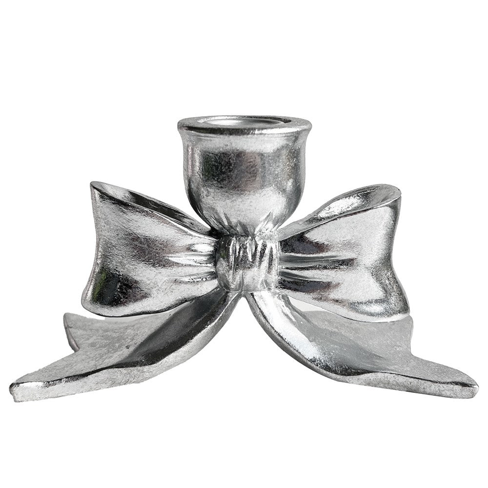 Silver bow shaped candle holder on a white background