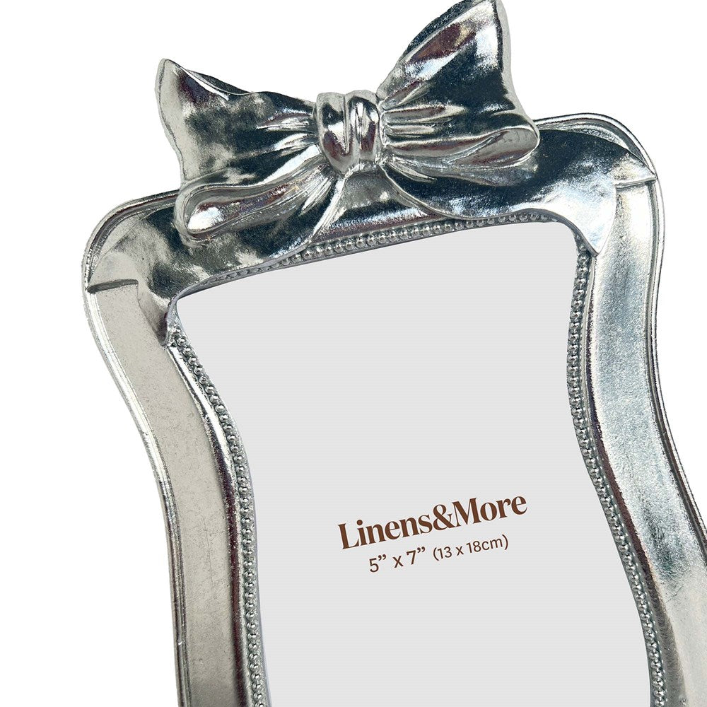 Close up of silver bow knot frame on a white background