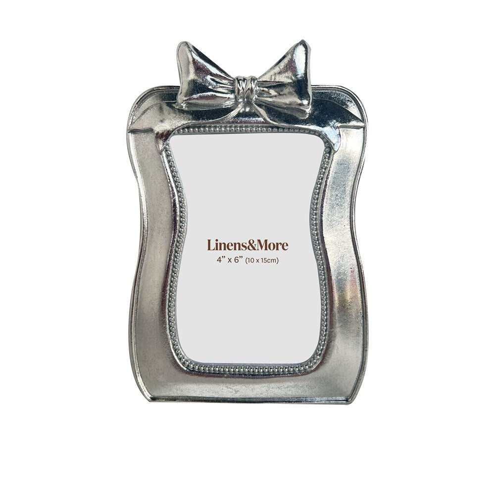 Silver bow photo frame with 'Linens & More' branding on a white background
