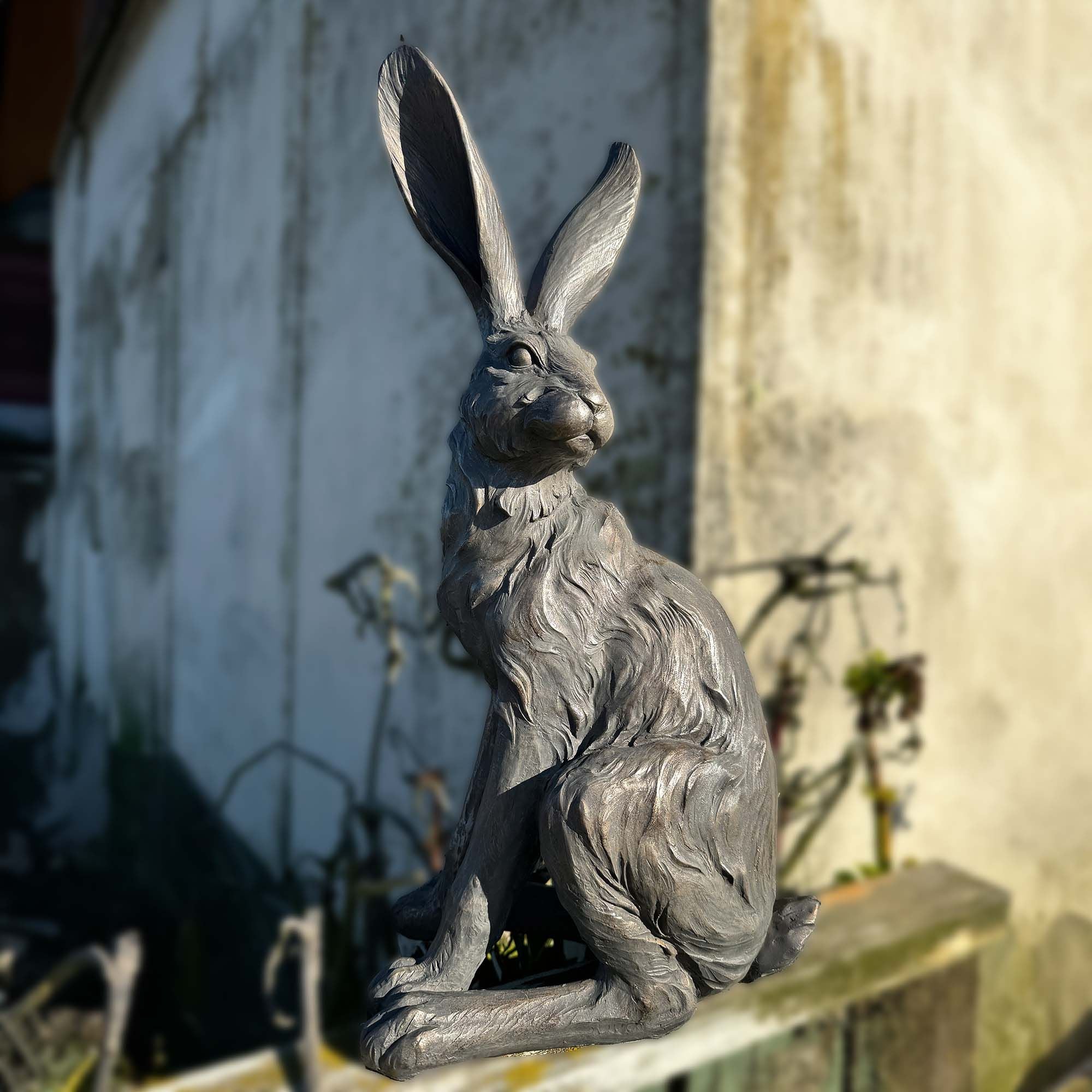 Statue of a hare on a wooden surface with a blurred background