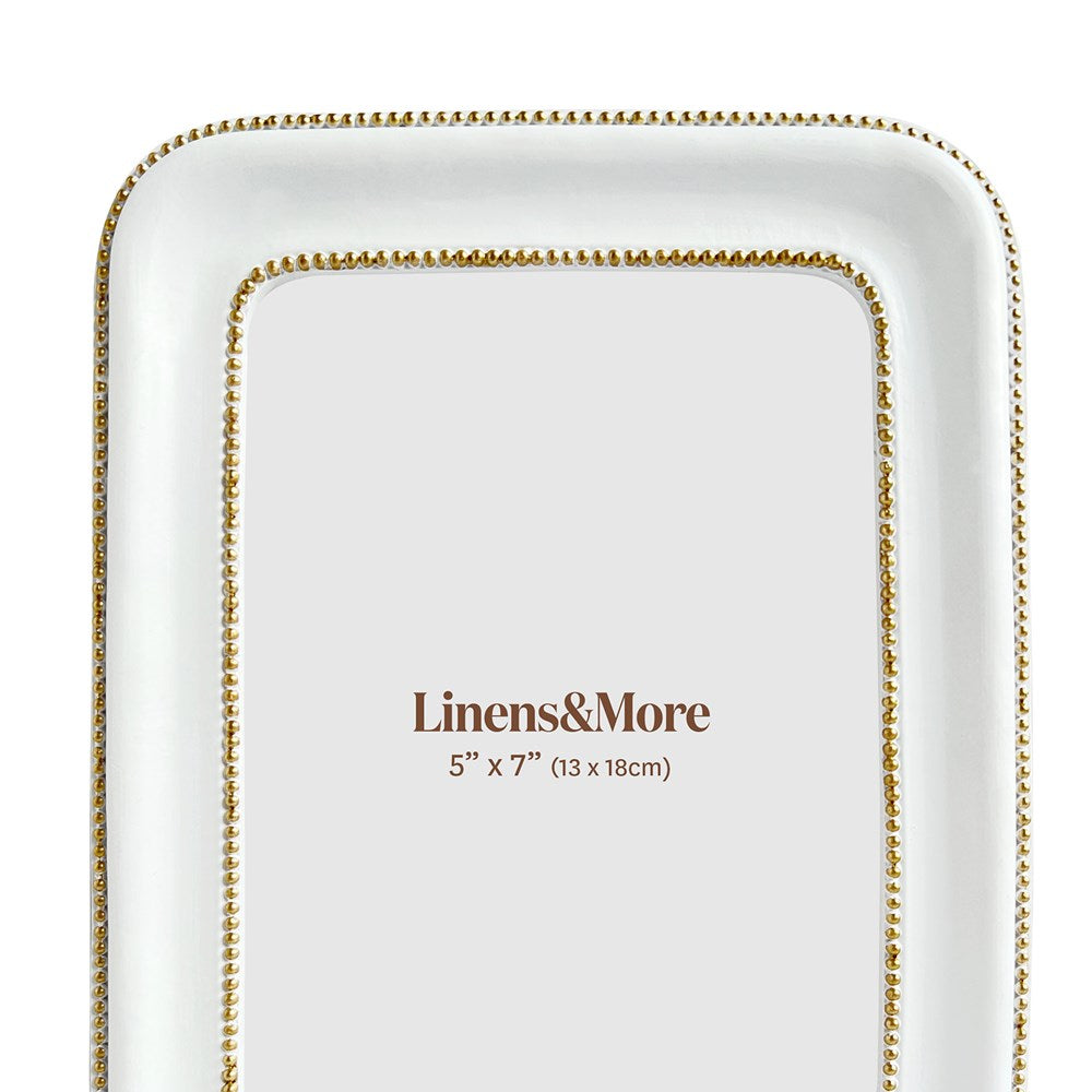 Close up of white and gold frame on a white background