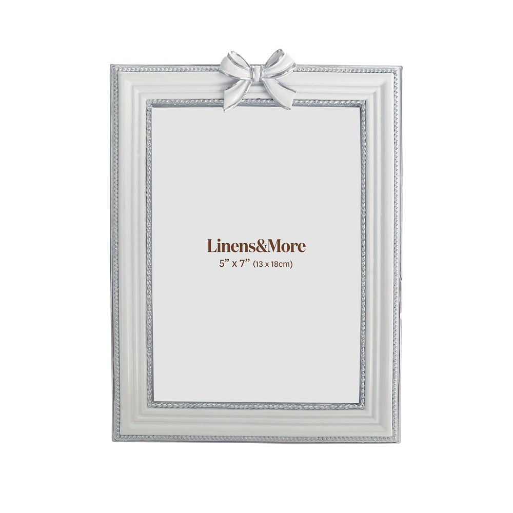 White and silver picture frame with a bow on a white background, featuring 'Linens&More' branding.