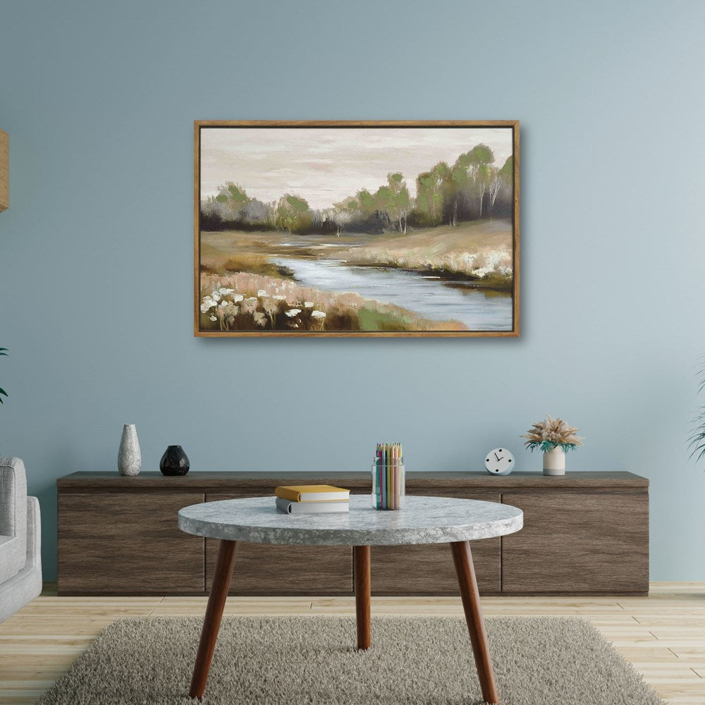 Living room with a painting of a landscape on the wall, a round marble coffee table, and wooden sideboard.