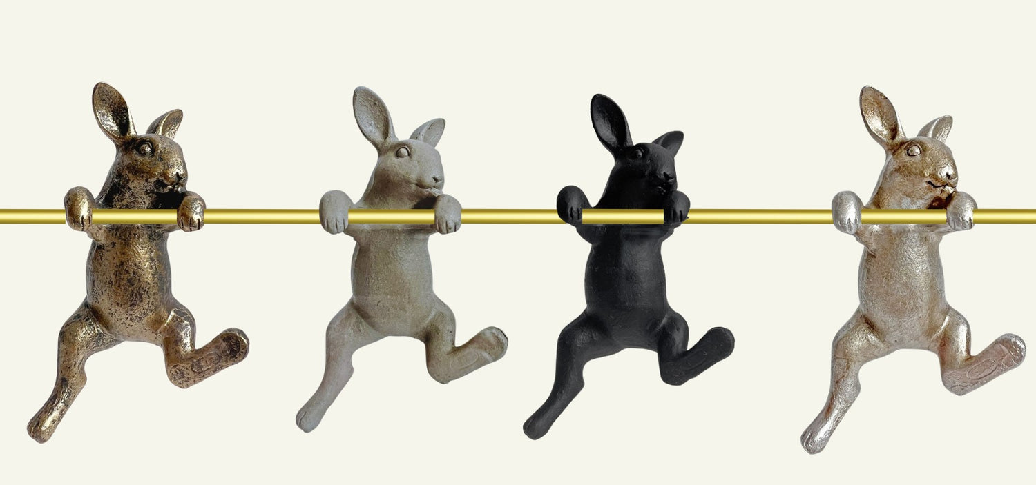 rabbit ornaments hanging on a gold rod